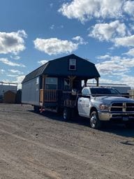 Truck hauling Lofted Barn Cabin