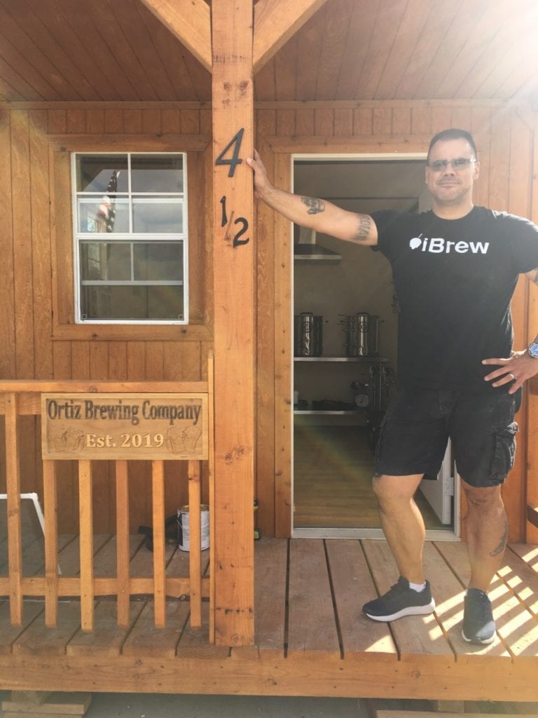 Man standing on porch of Deluxe Lofted Barn Cabinf