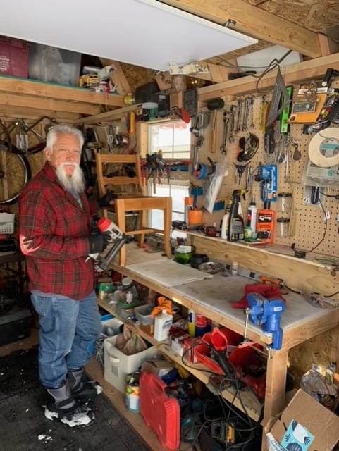 Man at Workbench inside Lofted Garage