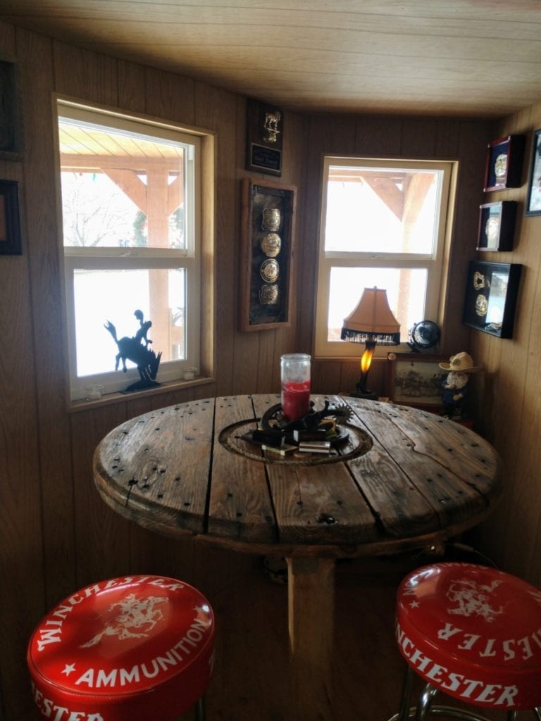 Wooden Table with Candle and Red Bar Stools