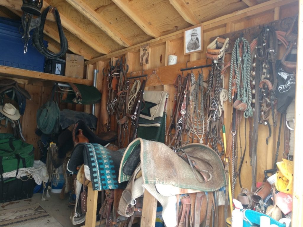 Close Up View of Horse Saddles and Items Stored in Garage