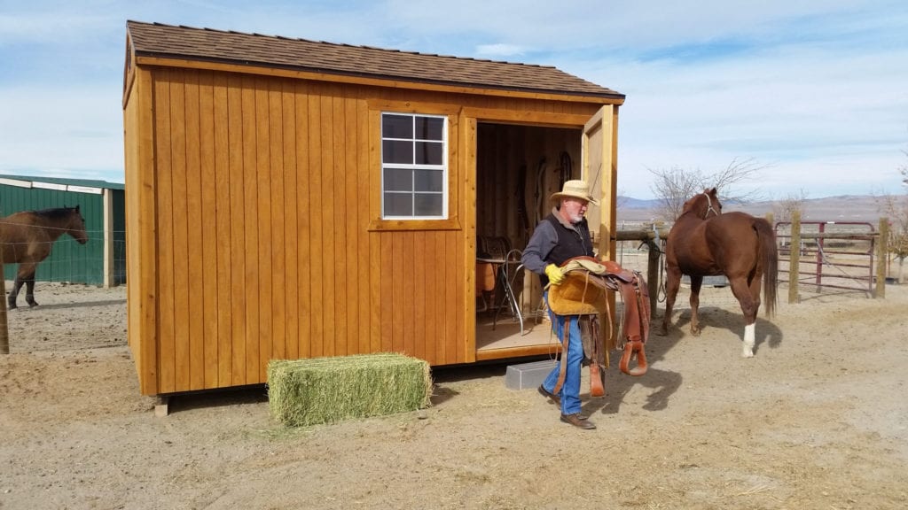 Man with Saddle coming out of the Side Door of the Garage