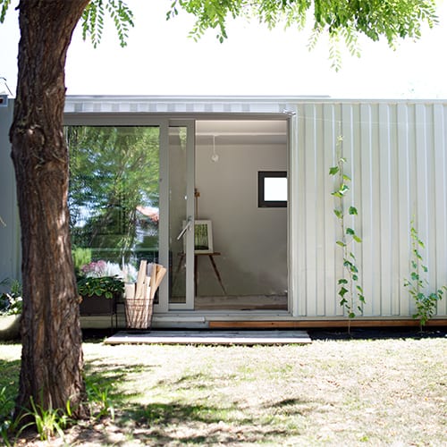 home office in container house in backyard