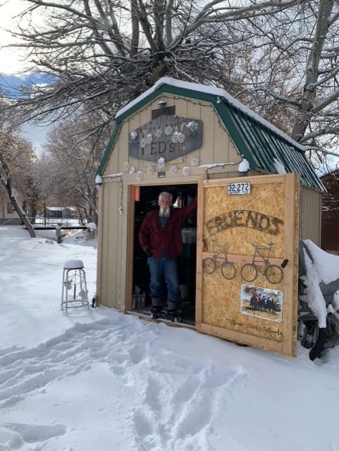 Man Standing in Doorway of Lofted Garage